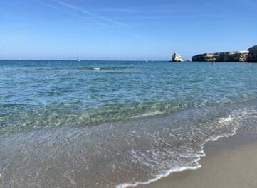 Sandy beach and cliffs in Torre dell'Orso, le due sorelle, Lecce, Italy