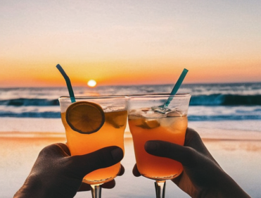 Activities in Salento. a couple enjoying a drink at the beach with sunset